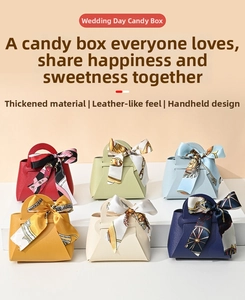 Detail of leather-textured wedding favor bags with elegant floral scarf bow handles
