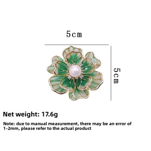 Detail view of enamel flower brooch with dimensions 5cm and 17.6g weight info