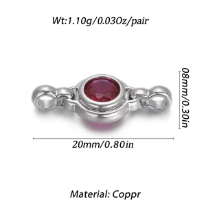 Detailed macro view of a silver copper connector with a round red zircon gemstone