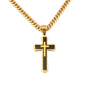 Close-up of gold Cuban chain necklace with layered gold and black cross pendant
