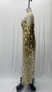 Detail of gold sequins and sheer mesh fabric on a sexy strapless evening gown