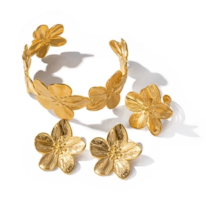 Golden flower jewelry set with brushed metal texture including bracelet, earrings and ring