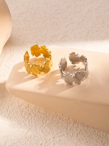 Detailed macro view of gold and silver leaf-shaped adjustable titanium steel rings