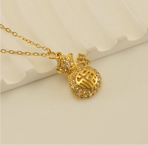 Macro view of 18k gold plated lucky bag pendant with sparkling crystals and hollow design