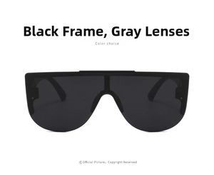 Detail view of oversized shield sunglasses featuring matte black frame and grey lenses