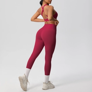 Rear view of red yoga set showing crisscross sports bra and high-waisted leggings