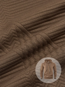 Macro detail of brown textured knit fabric on a men's long sleeve hooded sweatshirt