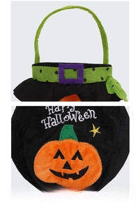 Detail of Halloween pumpkin candy bag showing sturdy green handle and felt embroidery