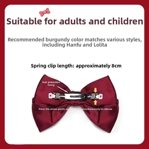 Detail view of wine red satin bow hair clip featuring a secure 8cm spring clip mechanism