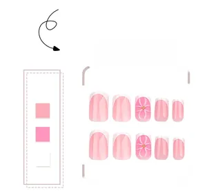 Detail of French ombre press-on nails with 3D ribbon bows and gold decorative beads