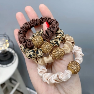 Satin hair scrunchies set with rhinestone balls in brown, leopard, gold and beige colors