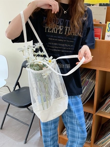 Minimalist white mesh tote bag with canvas base and shoulder straps for beach or shopping