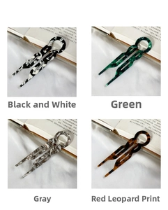 U-shaped hair pins in marble, agate, and leopard patterns on a white silk background