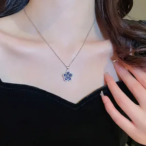 Elegant silver necklace featuring a blue zircon flower pendant with a halo of small crystals