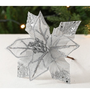 Detailed view of silver mesh Christmas flower with glitter sequins on snowy background