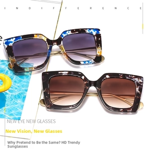 Detail view of marble and tortoise shell square sunglasses with slim gold metal temples