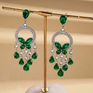 Detailed view of luxury silver tassel earrings with green zircon butterfly and water drop gems