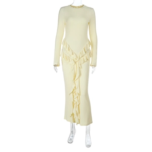 Close-up of the light yellow ribbed knit fabric and ruffled hemline on the long dress