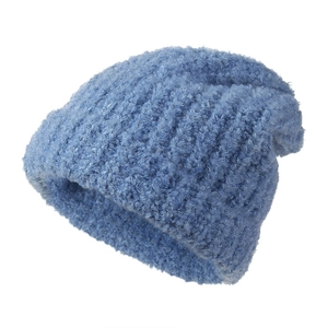 Close-up of sky blue knit beanie showing thick lambswool texture and warm braided fabric