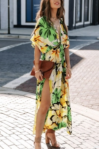 Detailed view of the side slit and floral print on the green chiffon maxi dress