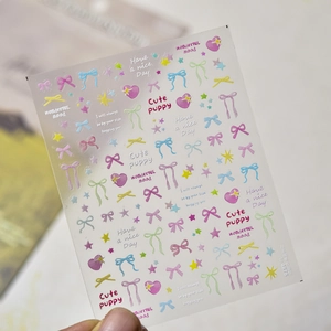 Macro shot of colorful laser butterfly and star nail art stickers on transparent film