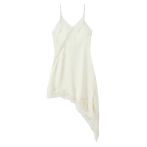 Detail of elegant lace patchwork and asymmetric hemline on a white satin slip dress