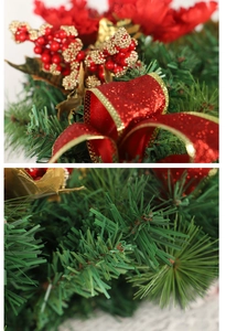 Detailed view of Christmas horn garland with red berries, gold-edged ribbon and pine needles