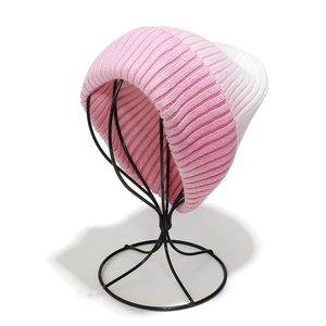 Detailed close-up of pink and white gradient tie-dye ribbed knit beanie for winter