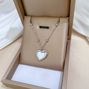 Silver titanium steel heart necklace with white shell inlay in a beige jewelry gift box