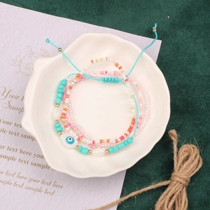 Detail of beaded bracelet set with turquoise beads, seed beads and evil eye charm