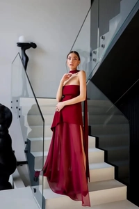 Detail of burgundy strapless dress with mesh splice and matching neck scarf on model