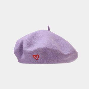 Detailed close-up of lavender wool beret featuring a delicate red embroidered heart