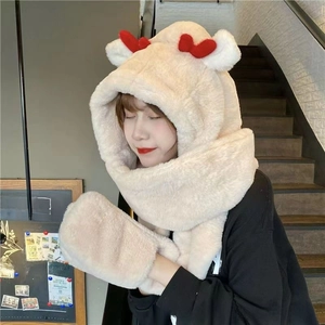 Detail of plush beige hooded scarf with red antlers and soft white round ears