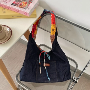 Detail of blue denim tote bag with vintage floral lining and zakka leather pocket patch