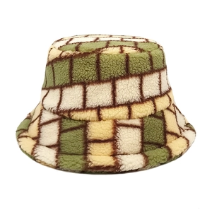 Detail of green and beige checkered faux fur bucket hat showing plush texture
