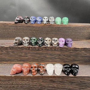 Detailed collection of 2.8cm carved gemstone crystal skulls in various natural minerals