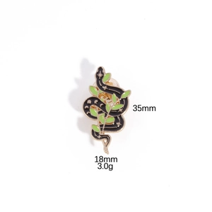 Detail shot of black snake and green leaf brooch showing dimensions 35mm x 18mm and 3.0g