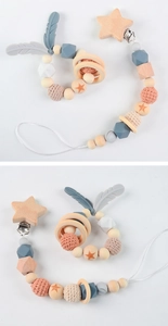 Close-up of beech wood and silicone baby pacifier clip set with knit beads