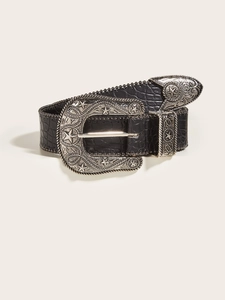 Detail of vintage western belt with embossed black leather and carved silver hardware