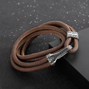 Close-up of brown braided leather bracelet with vintage silver magnetic clasp on gift box