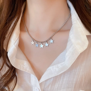 Detailed view of women silver ball chain necklace with five polished star pendants