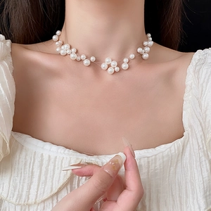 Close-up of a layered French style pearl necklace worn elegantly on a woman neckline