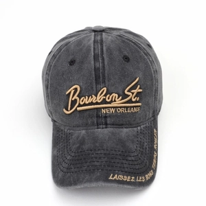 Detail of gold embroidery on washed cotton baseball cap with Bourbon Street lettering