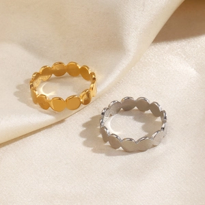 Minimalist scalloped geometric rings in gold and silver finish on silk fabric