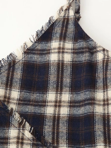 Detailed macro view of blue and white plaid fabric with frayed fringe edge design
