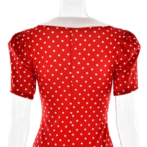 Detail view of red polka dot dress featuring short puff sleeves and back invisible zipper