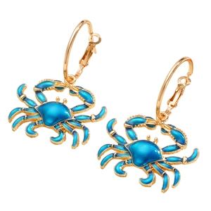 Detail of gold-plated alloy crab earrings with dark blue enamel finish on large hoops