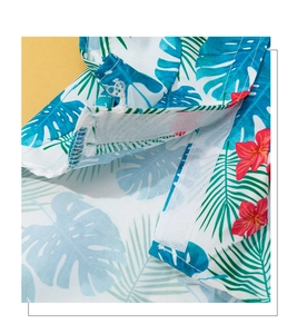 Macro detail of tropical pet shirt showing hook and loop fastener and palm leaf print