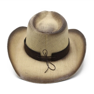 Detailed macro view of woven straw fibers and vintage brown gradient edge on cowboy hat