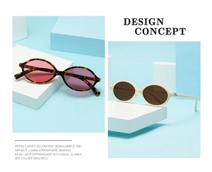 Detailed macro view of retro oval sunglasses with tortie and cream frames on geometric blocks